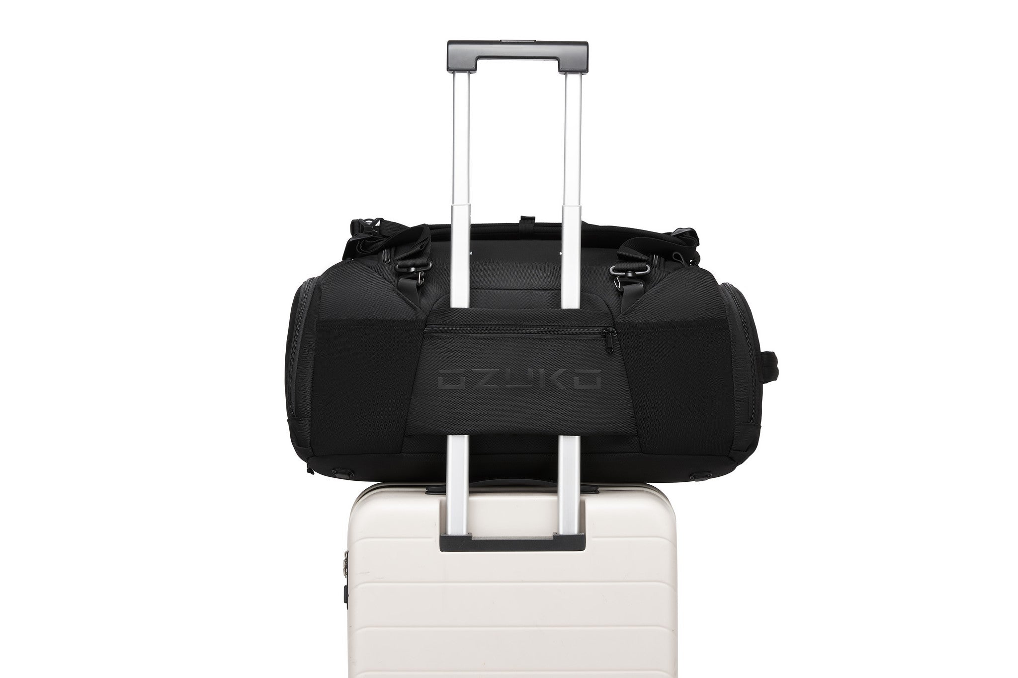 Black Voyager Duffel 40L with the base pass-through strap slid over a rolling suitcase handle