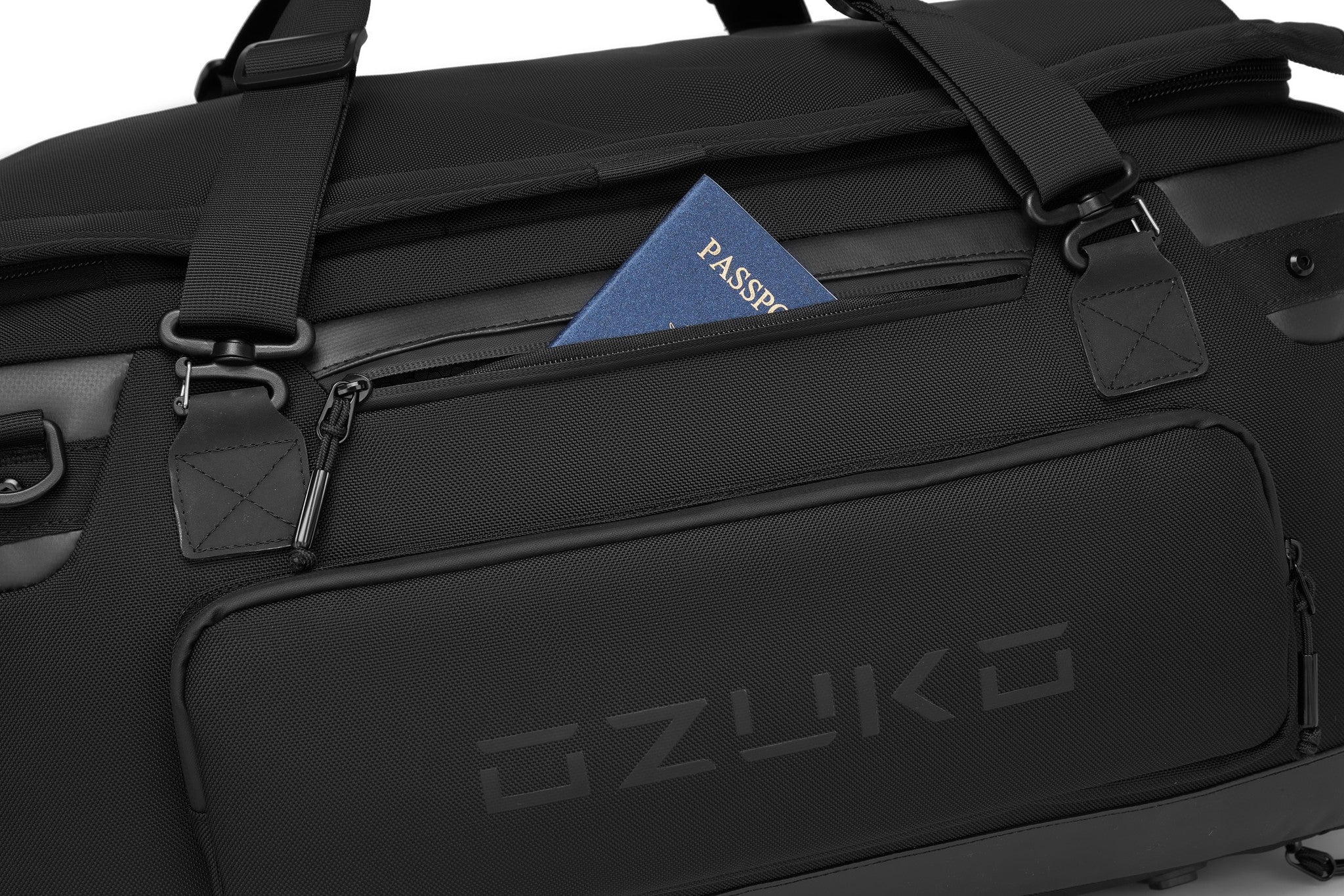 Close-up of the Oono Voyager Duffel 50L's top zip pocket holding a passport for quick access