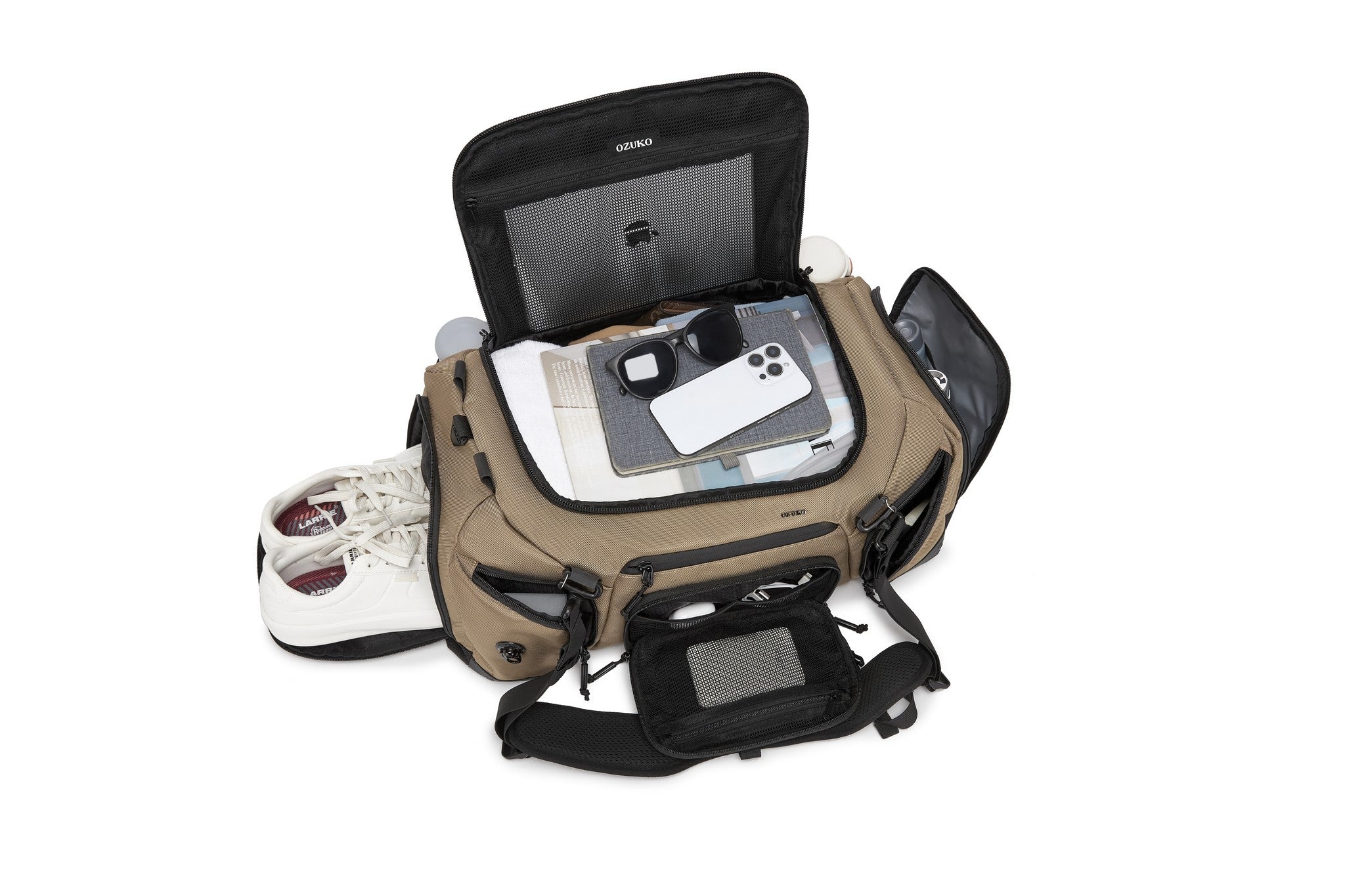 Interior lid pocket packed with white sneakers, a notebook, sunglasses, and a phone, Tan exterior visible at the edges