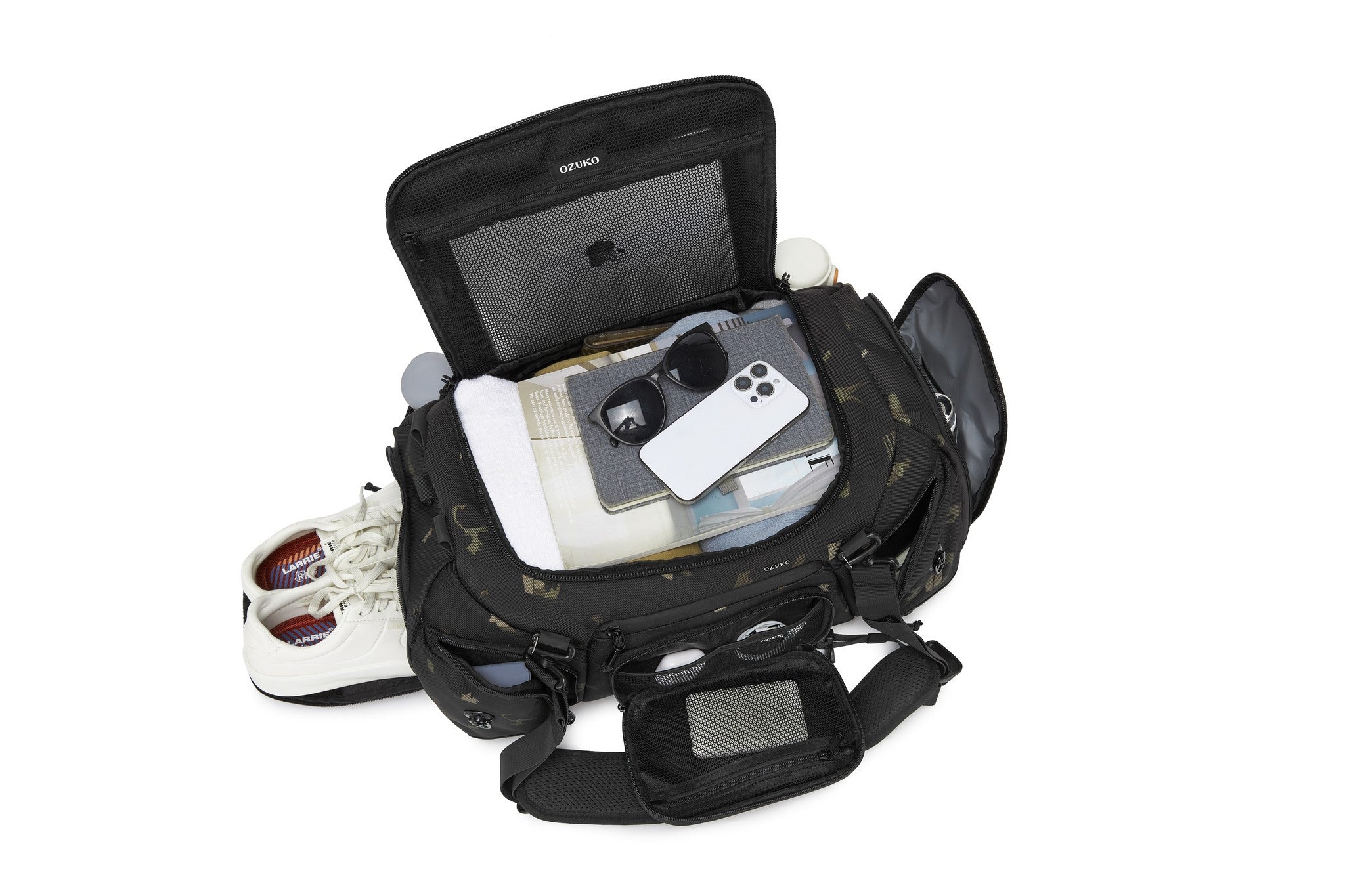 Interior lid pocket packed with white sneakers, a notebook, sunglasses, and a phone
