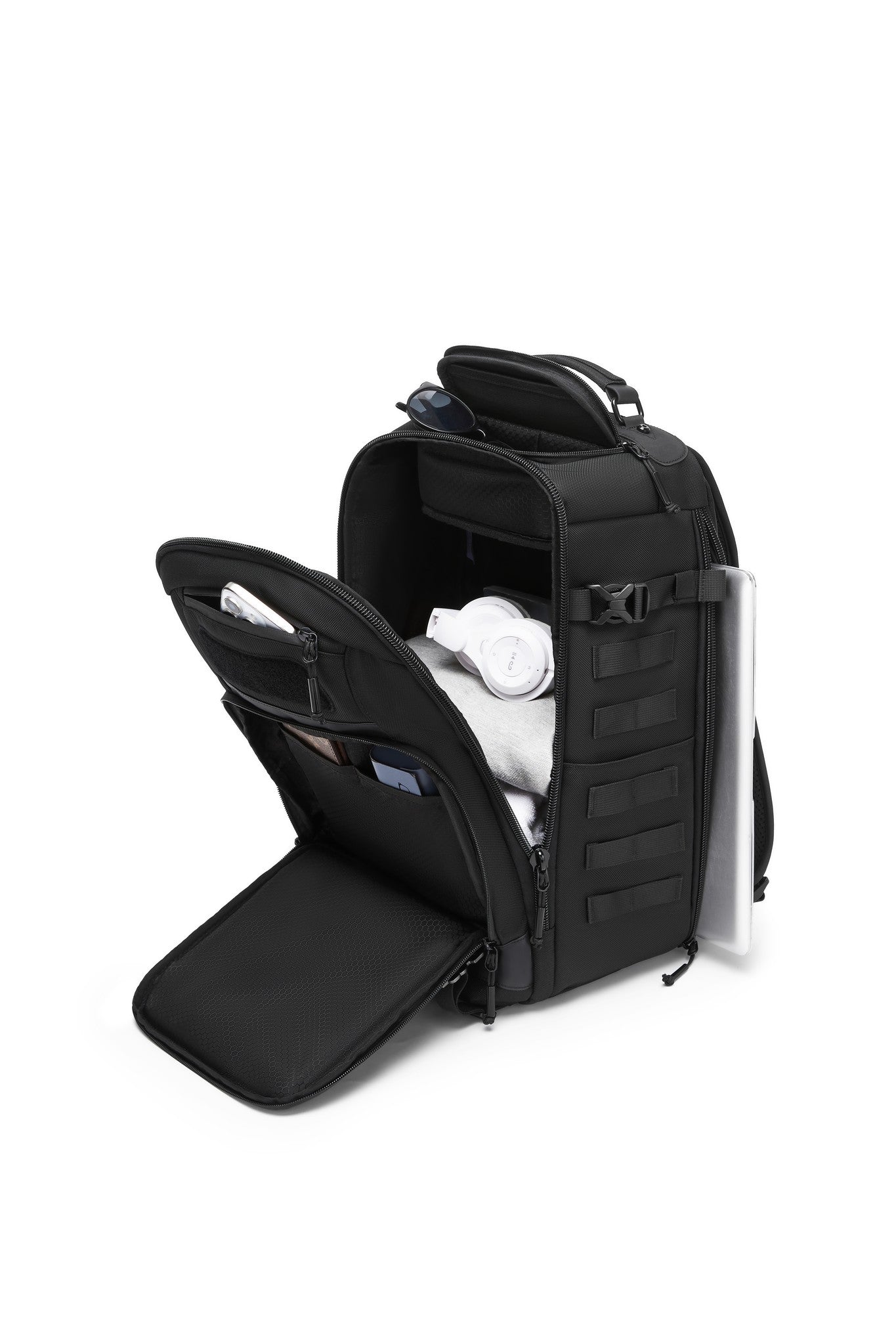 Oono Trailhead Backpack 25L in black, main compartment open and packed with notebooks, sunglasses, and a phone, with a mesh pocket in the lid