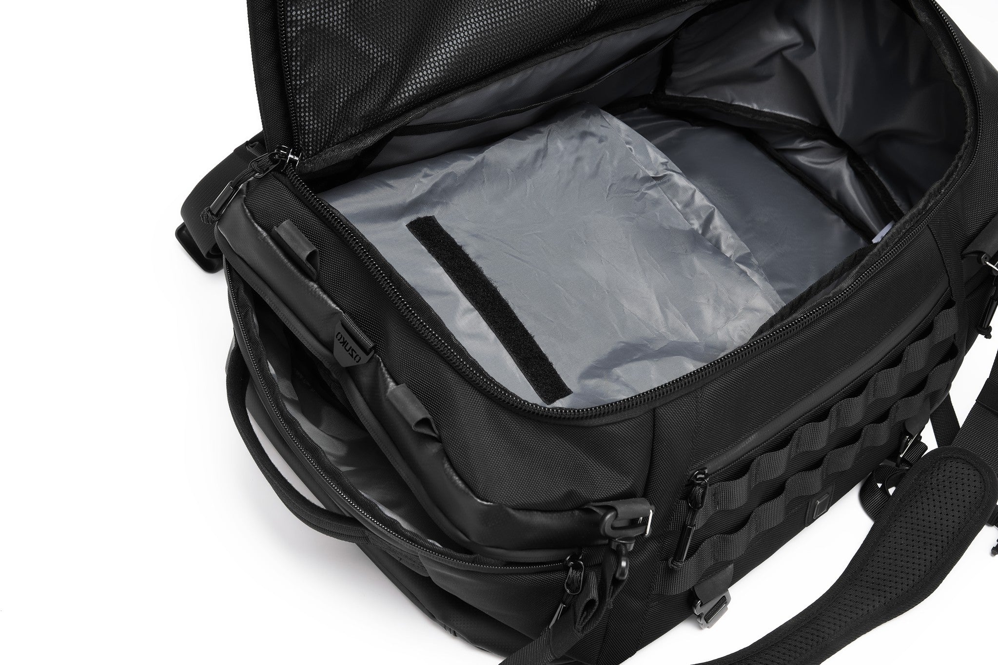 Open main compartment interior showing the fully coated lining, with a hand lifting the velcro-secured mesh document pocket
