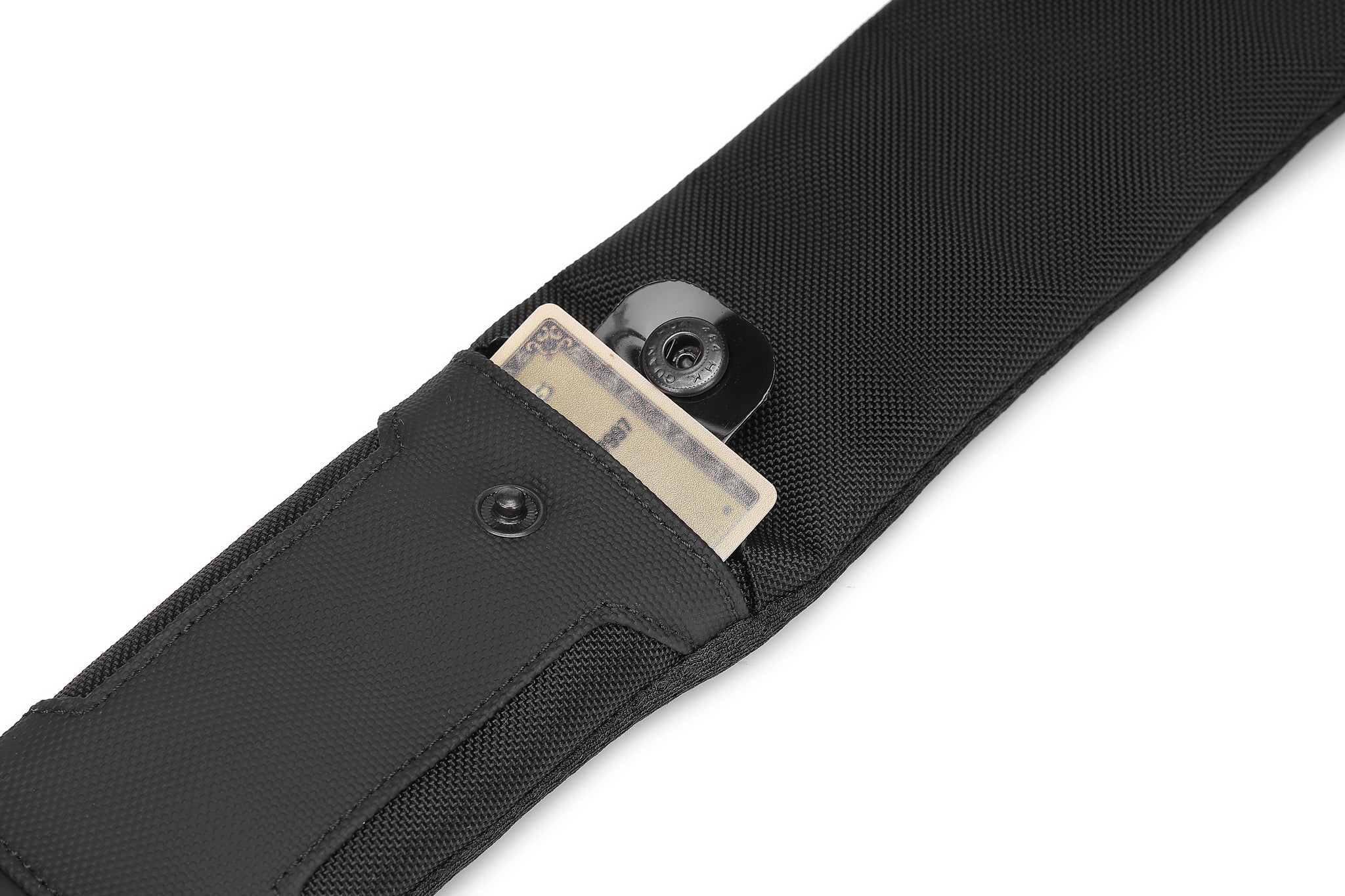 Ridge Sling 8L in Black, close-up of the strap-mounted card slot with a card tucked into the snap closure
