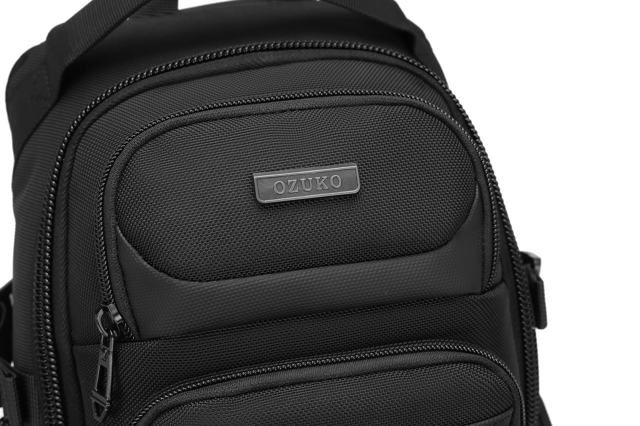 Ridge Sling 8L in Black, close-up of the molded top pocket with the OZUKO badge